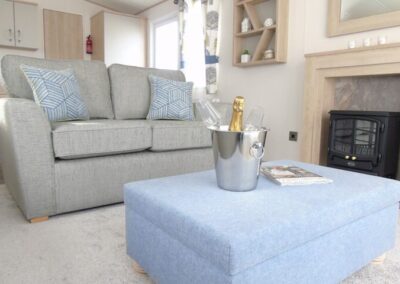 ABI Saffron static caravan lounge sofa detail with blue cushions - West Point Beach Resort
