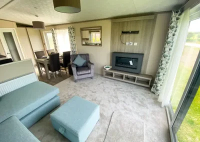 Caravan lounge with blue sofas and fireplace - West Point Beach Resort