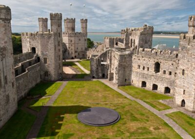 Caernarfon Castle towers and grass courtyard - West Point Beach Resort