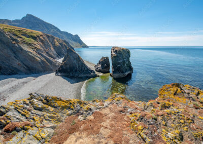 Rocky sea arch on North Wales coastline at sunset - West Point Beach Resort