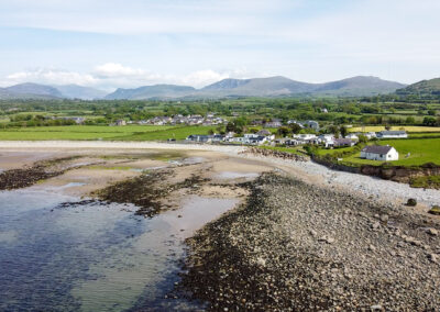 Aerial view of West Point Beach Resort coastline and mountains - West Point Beach Resort