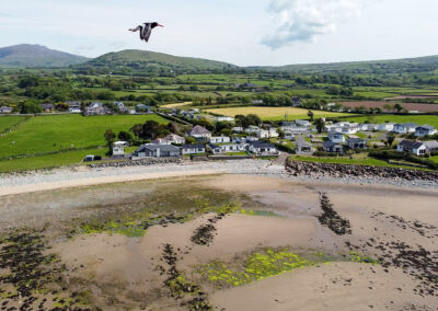 Aerial view of West Point Beach Resort with estuary and mountains - West Point Beach Resort